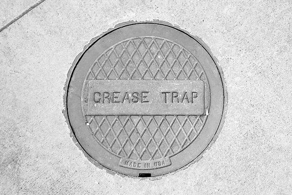 grease trap pumping involves removing the accumulated grease and solids from the trap